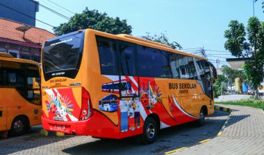 Jakarta, Indonesia - July 16, 2019:  Free school bus parking on Jalan Cengkeh, West Jakarta. 