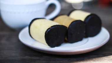 Bandung, Batı Java, Endonezya ve ahşap arka plan üzerinde içecek bir fincan Muz rulo kek.