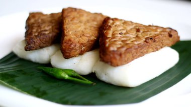 Muz yaprağı üzerinde Jadah bacem. Jadah, tempe bacem ile birleşti. Yogyakarta 'dan Endonezya yemekleri.