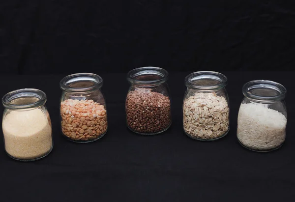 Five Different Types Cereals Jars Black Background Porridge Healthy Food — Stock Photo, Image
