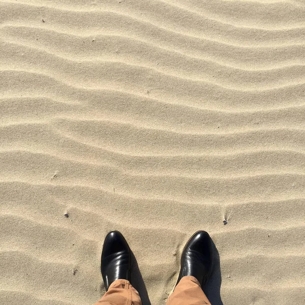 in shoes on sand