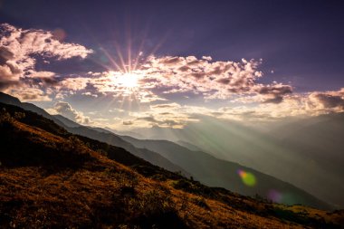 Dağlarda görkemli gün batımı, güzel renkler mavi ve turuncu gökyüzü