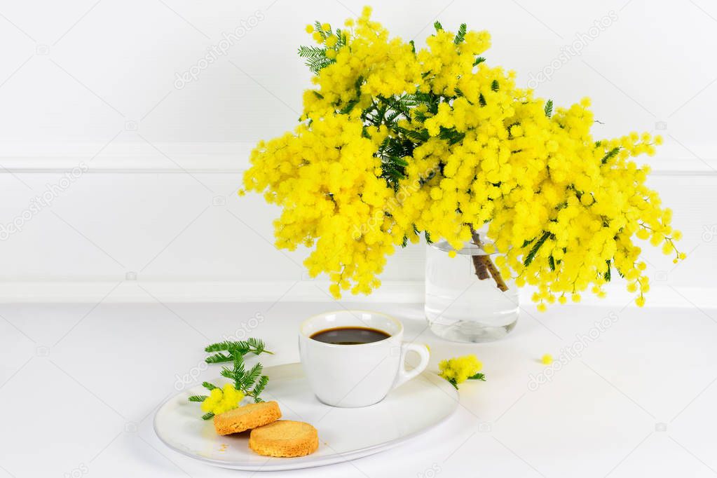 Yellow mimosa and a cup of coffee.
