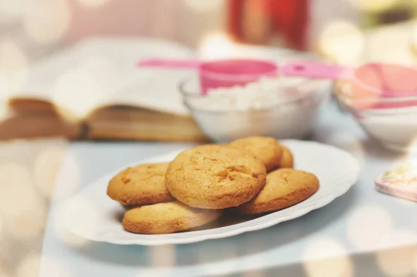 Cooking Christmas cookies on the table with a book of recipes.