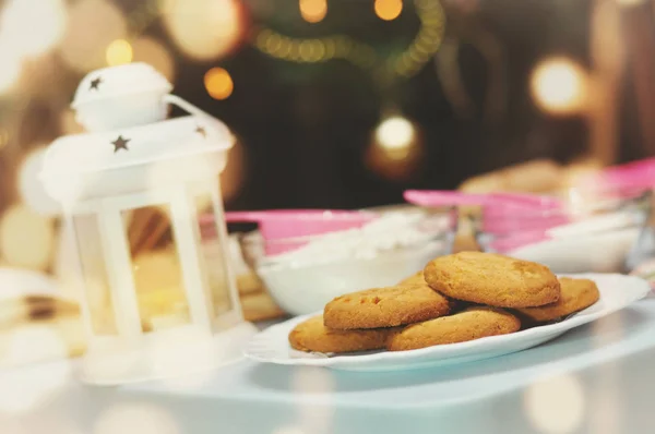 Cooking Christmas cookies on the table with a book of recipes.