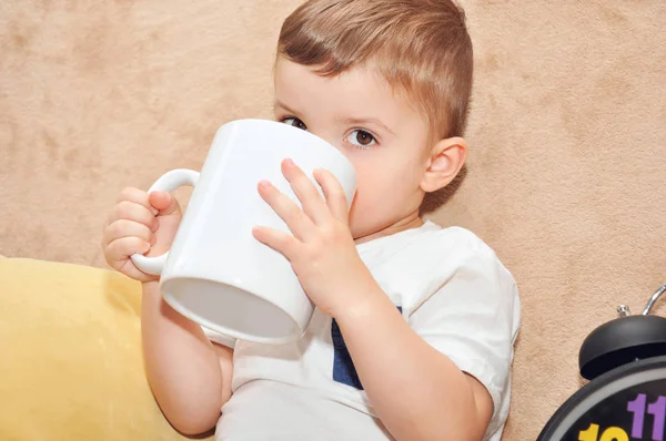 Cute Little Boy White Shirt Sits Sofa Home Drinks Large — Stock Photo, Image