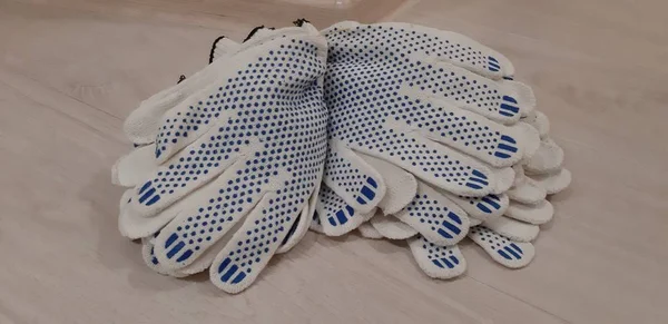 Gloves with perforated plastic coating for working in the garden, on the farm, for repairing and working behind the machine