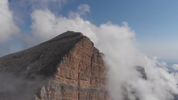 Toma aérea de volar sobre los picos de la montaña entre las nubes. — Vídeos de Stock