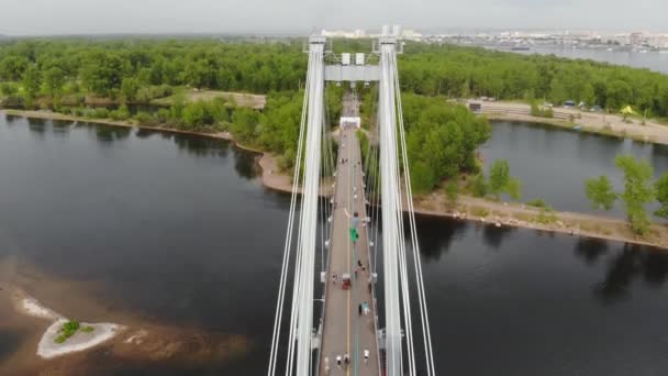 Чоловік ходить на мотузці, розтягнутій між опорами мосту на великій висоті . — стокове відео