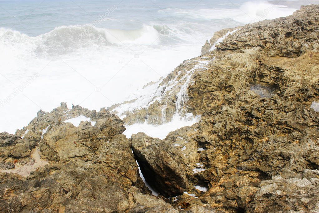 Landscape of strong waves crashing on rock in Barbados island