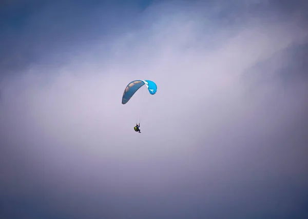 Para-glider flying in mid air over the beach, at daytime, San Pedro, Manabi, Ecuador