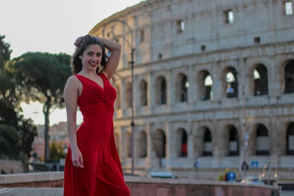 Красивая девушка в красном платье перед Колизеем, Рим, Итал — стоковое фото