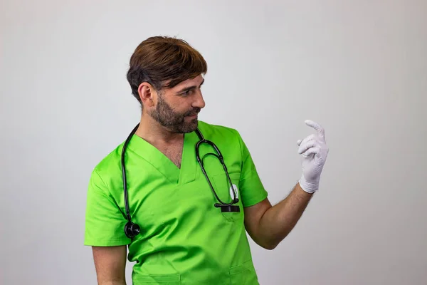 Portrait of male veterinary doctor in green uniform with brown h