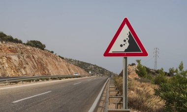 Heyelan tehlikesi işareti ve asfalt yol 
