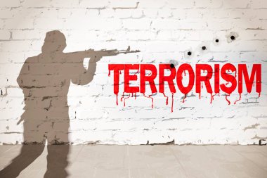 Terörizm kavramı. Shot tuğla duvar üzerinde kırmızı yazıt 