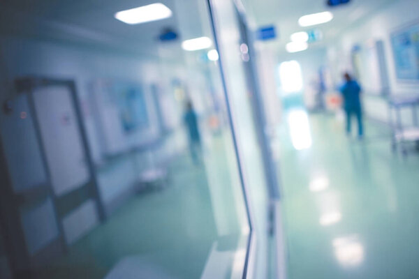 Medical worker walks along the corridor of the hospital during n