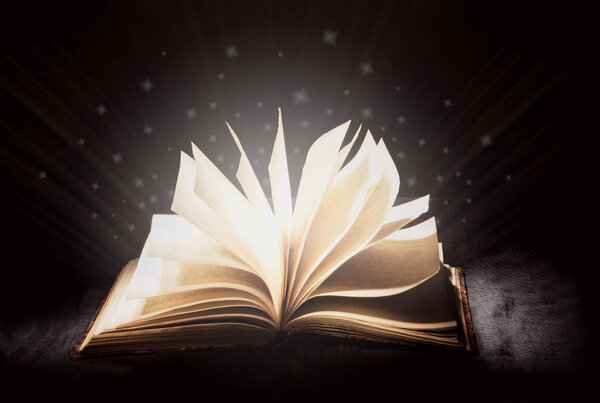 Open magic book, blue cool white light from a book, magic, true knowledge, light of science