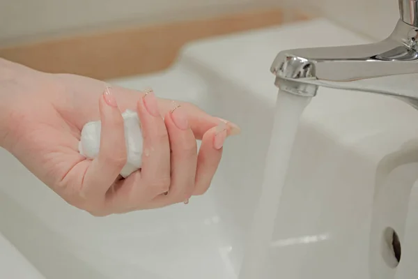 white bubbled foam in hands in sink, hair foam, foam for man, white textured, hand full of soap near water tap
