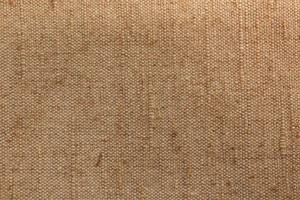 old, rough hand-made fabric, burlap or canvas, natural fibers and color, linen background