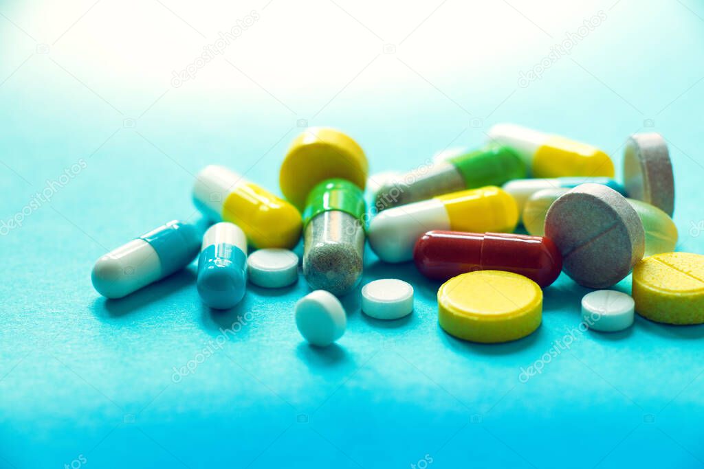 different medicines, many different types and colors of tablets and capsules, the concept of a pharmacy, prescription and taking a large number of medications