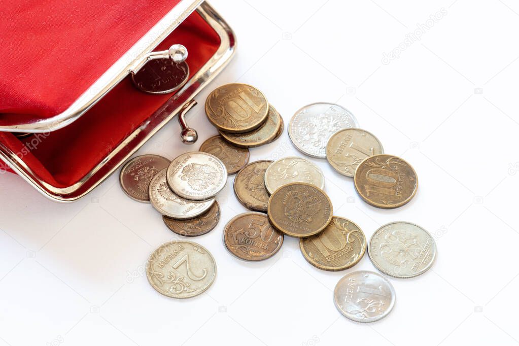 red vintage wallet, Russian coins, rubles and copecks close-up, the concept of a living wage, social pension, indexation of pension payments