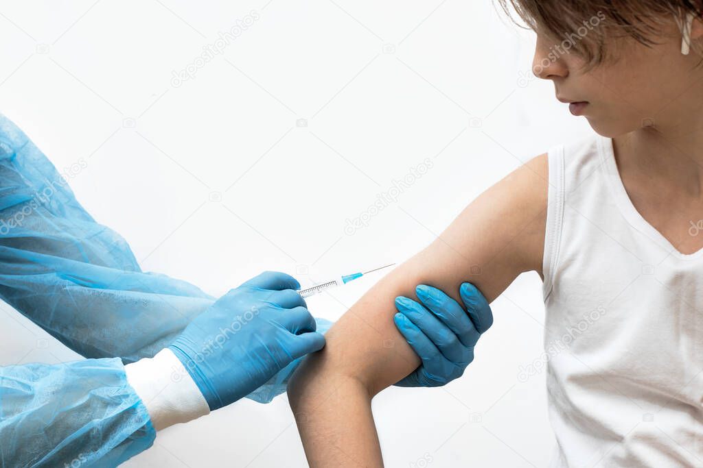 the doctor gives an injection to the patient, testing the vaccine, hands in blue medical gloves hold a syringe with medicine, vaccination against flu and coronovirus