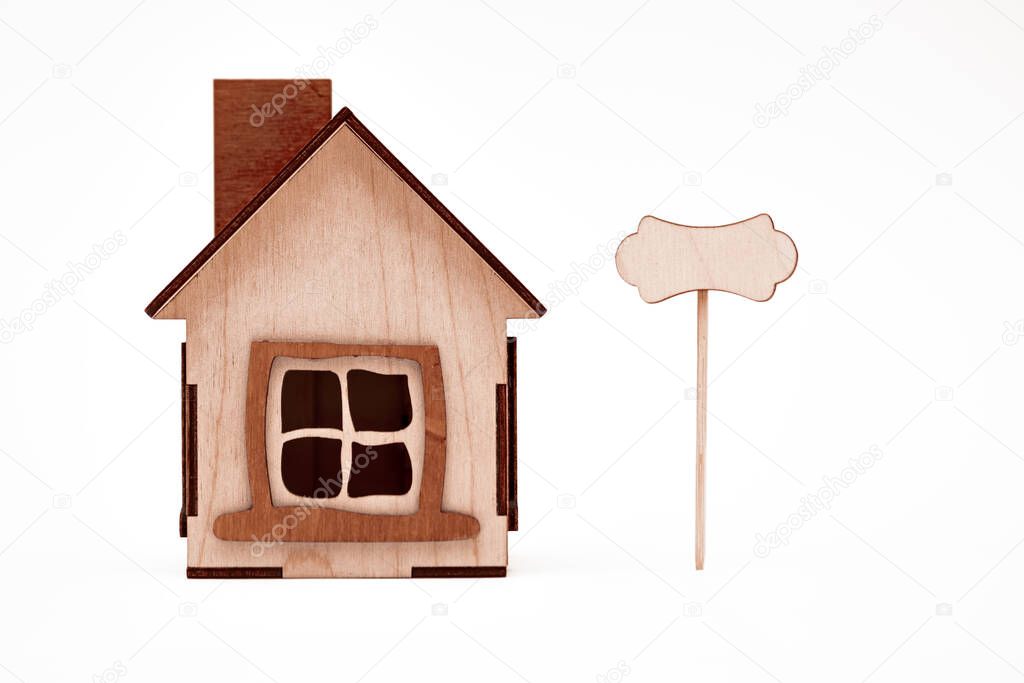 model of a wooden house on a white background, real estate agency concept, sale, rental apartments, real estate houses concept
