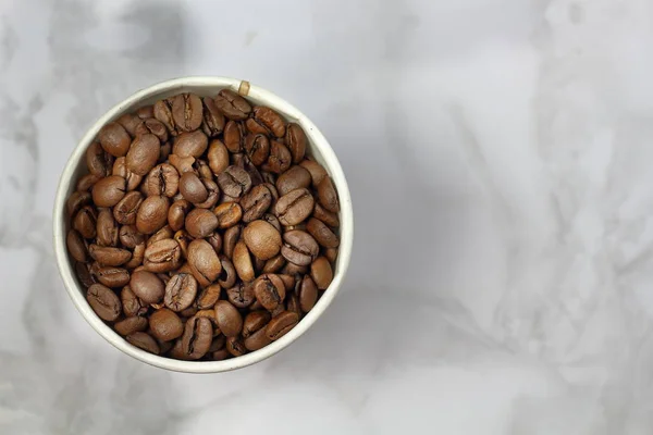 Coffee Beans Paper Cup Marble Surface Top View Copy Space — Stock Photo, Image