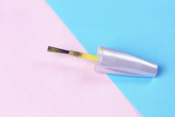 Yellow nail  brush on pink background. Nail service industry