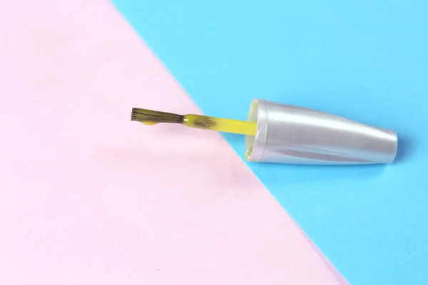 Yellow nail  brush on pink background. Nail service industry