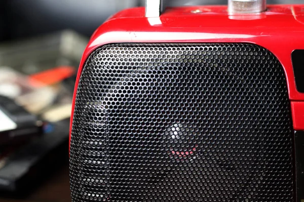 Red audio radio with balck speaker closeup retro vintage 90\'s style