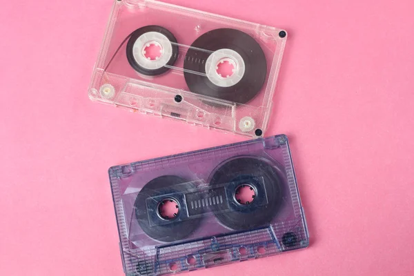 group of two audio retro vintage cassete tape 80s style on pink background