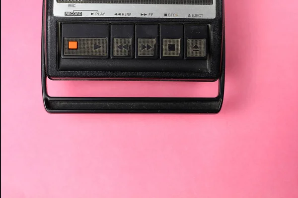 Old retro vintage 80s style portable  audio  tape cassette  recorder radio  on a pink background
