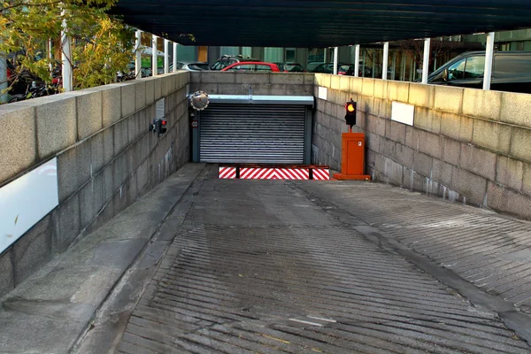 Entrance to the underground parking garage with tiles with yellow traffic lights