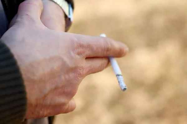 Cigarette in the brutal male hand. Smoking is a bad habit
