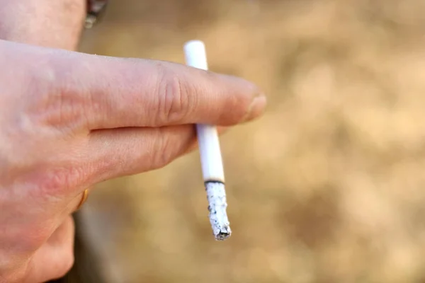 Cigarette in the brutal male hand. Smoking is a bad habit
