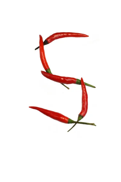 Alphabet of hot spice cayenne chili peppers isolated on white. Vegetable chili peppers in shape of letter S, for making words and logo