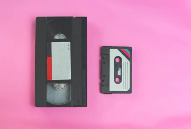 Video kaset vhs ve ses kaset retro vintage ruhu 1970'lerde, 1980'lerde, seçici odak ile pembe arka plan üzerinde 1990'larda tarzı