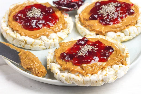 crunchy natural peanut butter strawberry jam jelly sandwich with chia seeds on rice cake bread. Proper nutrition diet vegetarian breakfast