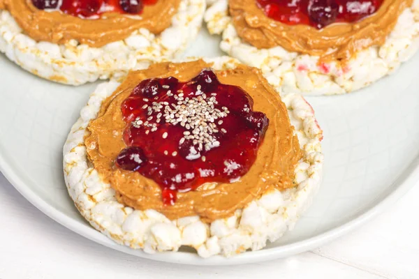 crunchy natural peanut butter strawberry jam jelly sandwich with chia seeds on rice cake bread. Proper nutrition diet vegetarian breakfast