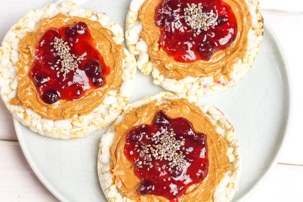 crunchy natural peanut butter strawberry jam jelly sandwich with chia seeds on rice cake bread. Proper nutrition diet vegetarian breakfast