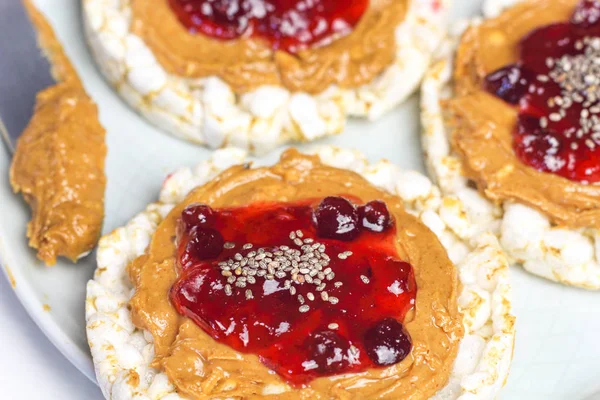 crunchy natural peanut butter strawberry jam jelly sandwich with chia seeds on rice cake bread. Proper nutrition diet vegetarian breakfast