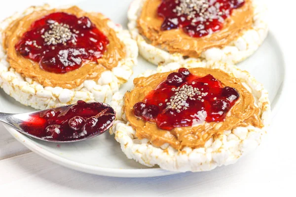 crunchy natural peanut butter strawberry jam jelly sandwich with chia seeds on rice cake bread. Proper nutrition diet vegetarian breakfast