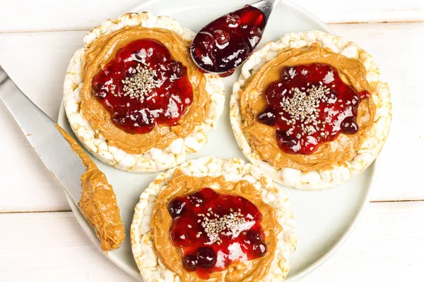 crunchy natural peanut butter strawberry jam jelly sandwich with chia seeds on rice cake bread. Proper nutrition diet vegetarian breakfast