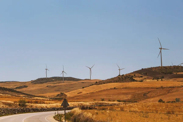 wind power plant windmill energy electricity on the yellow hills soft selective focus