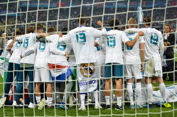 KYIV, UKRAINE - MAY 26, 2018: Footballers of Real Madrid steel in a row behind the grid celebrate the victory in the final of the UEFA Champions League 2018 in Kiev , Ukraine