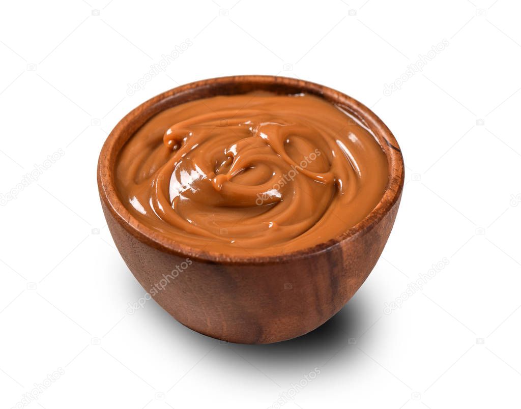 Dulce de leche on wooden bowl