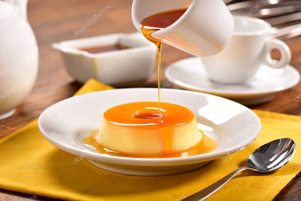 Vanilla pudim with caramel sauce on decorated scene