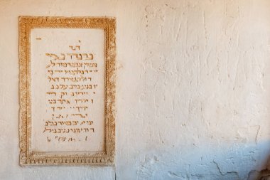 Inscription in Hebrew on the wall of kenassa (synagogue) in Chufut-Kale, medieval cave settlement of Crimean Karaites, Crimea clipart