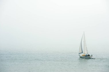 Sailing in the dense fog in Atlantic ocean near Bass Harbor, Maine, USA clipart
